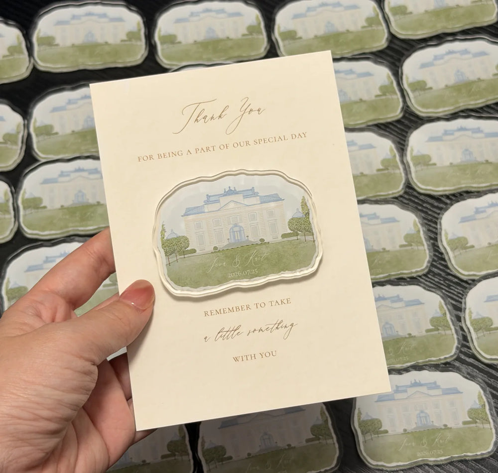 Rows of pale manor acrylic magnets beside a matching wedding thank-you card.