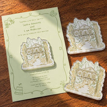 Three custom venue-shaped acrylic magnets with olive line art and a pale green invitation card