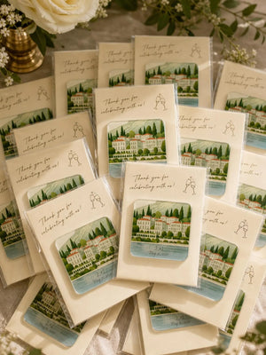 Stack of custom 3mm wedding venue acrylic magnets on ivory thank-you cards